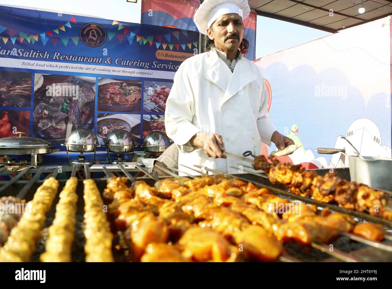 Islamabad, Pakistan. 26th Feb, 2022. A chef prepares food during 'Islamabad Eat' food festival in Islamabad, capital of Pakistan, Feb. 26, 2022. Islamabad Eat, a famous food festival of the Pakistani capital, returned to the city in its true spirit, after a two-year absence induced by the outbreak of COVID-19, which halted many other excursion and sports activities in the country besides the festival. Credit: Ahmad Kamal/Xinhua/Alamy Live News Stock Photo