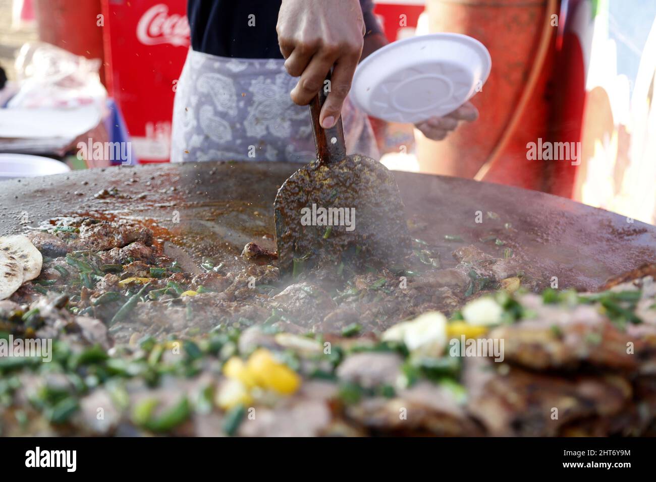 Islamabad, Pakistan. 26th Feb, 2022. A chef prepares food during 'Islamabad Eat' food festival in Islamabad, capital of Pakistan, Feb. 26, 2022. Islamabad Eat, a famous food festival of the Pakistani capital, returned to the city in its true spirit, after a two-year absence induced by the outbreak of COVID-19, which halted many other excursion and sports activities in the country besides the festival. Credit: Ahmad Kamal/Xinhua/Alamy Live News Stock Photo