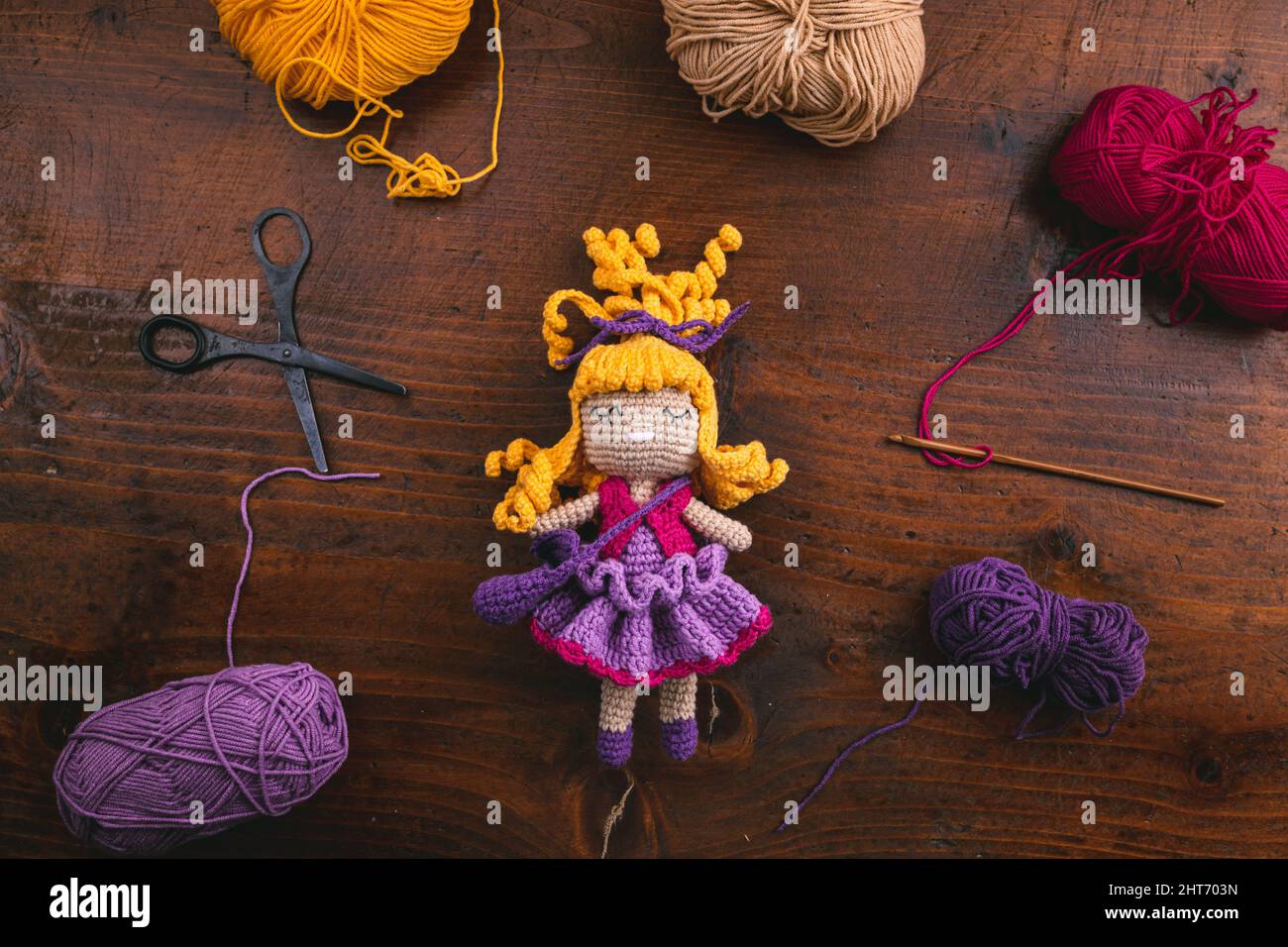 Product photo of a handmade crochet toy doll for kids with its tools