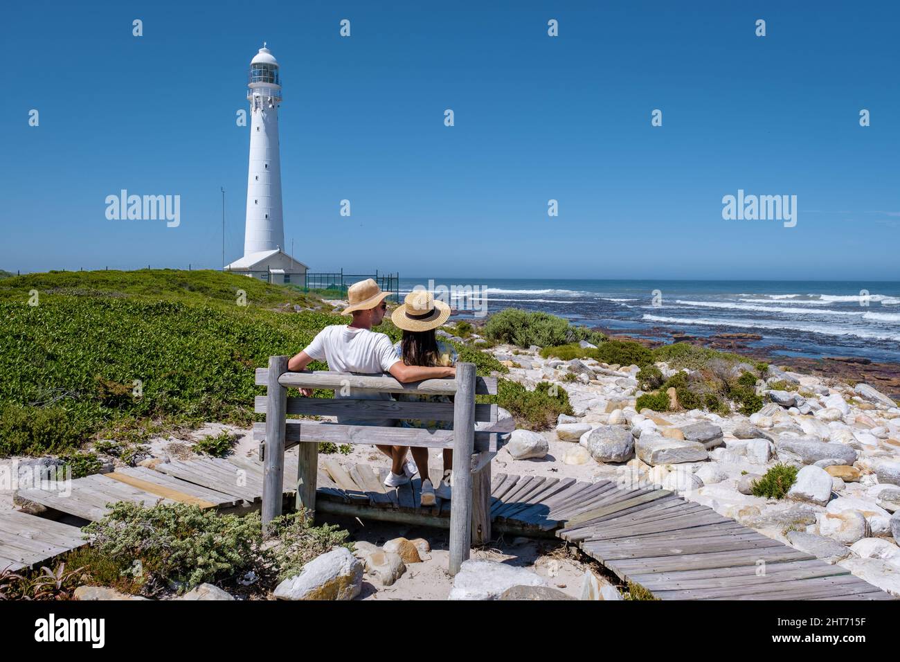 Couple man and women visiting the lighthouse of Slangkop Kommetjie Cape Town South Africa, The Slangkop lighthouse in the village of Kommetjie on the Cape Town Peninsula.  Stock Photo