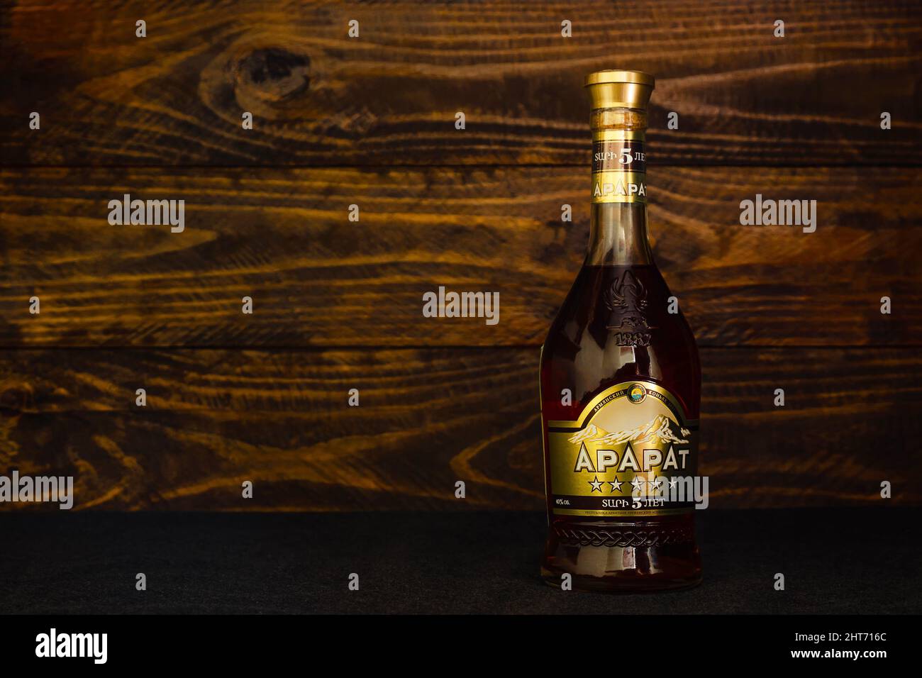 A bottle of Ararat Armenian brandy 5 years old on a dark wooden background. Ararat Cognac is a national legend, embodying the unique spirit of Armenia Stock Photo