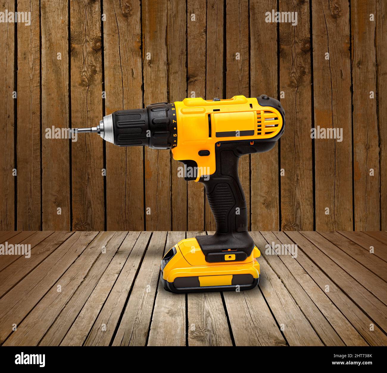 https://c8.alamy.com/comp/2HT738K/yellow-electric-cordless-screwdriver-drill-on-wooden-background-professional-home-repair-tool-2HT738K.jpg