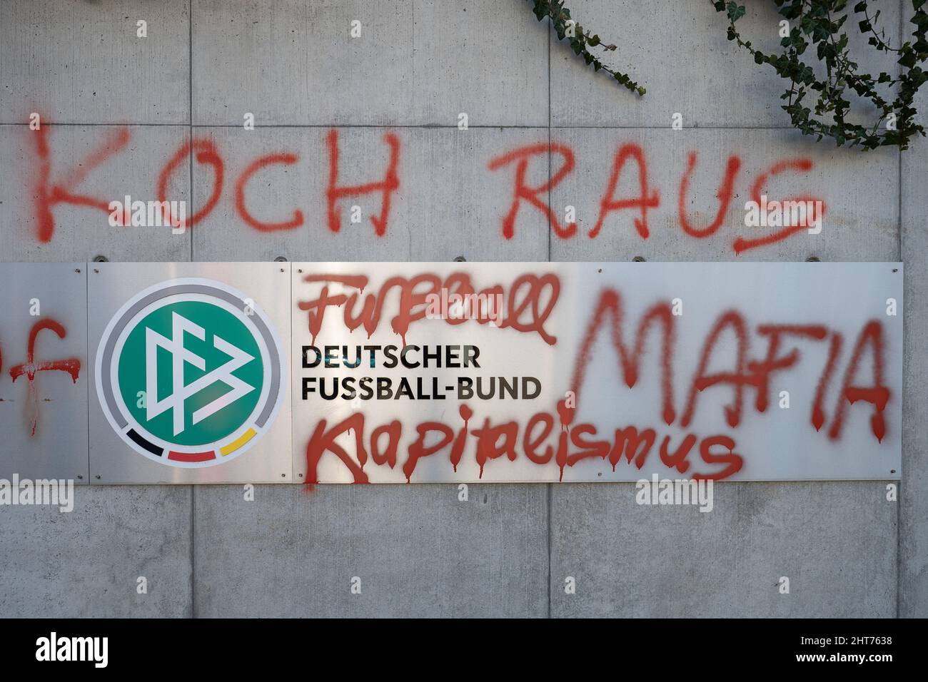 27 February 2022, Hessen, Frankfurt/Main: The slogans 'Koch raus' ('Koch out') as well as 'Fussball Mafia' ('Football Mafia') and 'Kapitalismus' ('Capitalism') are written on the DFB headquarters. The German Football Association has filed charges because of a graffiti on the association's headquarters in Frankfurt. (to dpa 'Because of graffiti on association headquarters: DFB files charges') Photo: Sebastian Gollnow/dpa Stock Photo