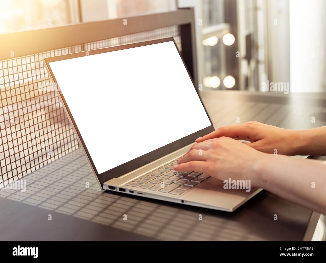 Woman hands closeup typing on laptop mockup. Hands over computer keyboard. Student or worker sitting at table and typing email, searching information on Internet, preparing presentation or research. High quality photo Stock Photo