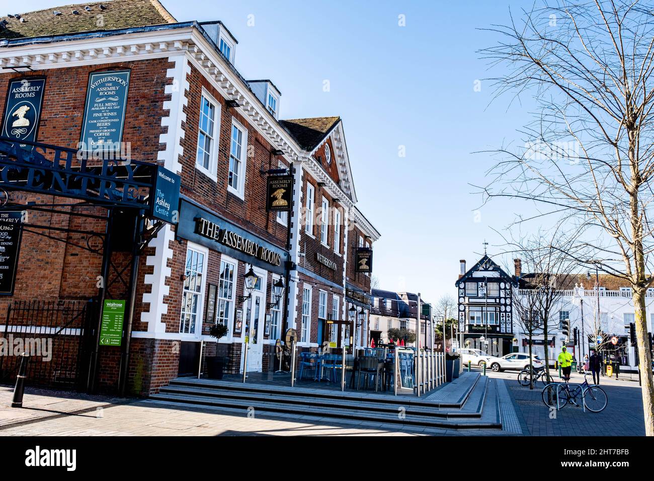Epsom Surrey UK, February 27 2022, Wetherspoons Pub Building Exterior With People Walking Under Clear Blue Sky Stock Photo