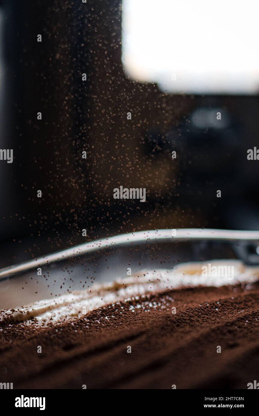 Closeup of cocoa powder falling on a tasty tiramisu tray Stock Photo ...