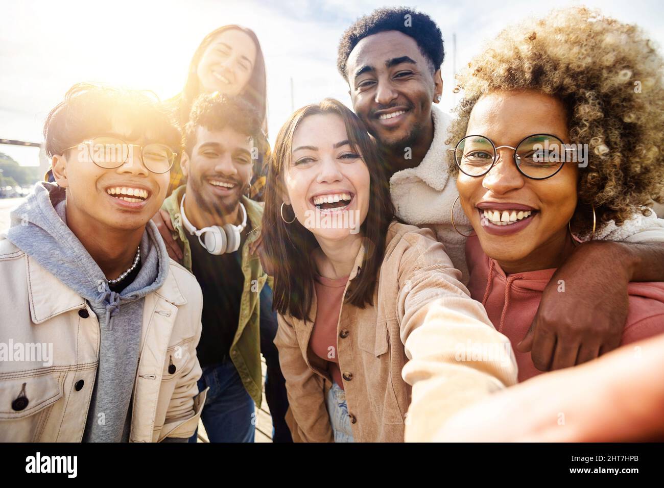 Happy young friends having fun while taking a selfie with mobile phone outdoors  Stock Photo