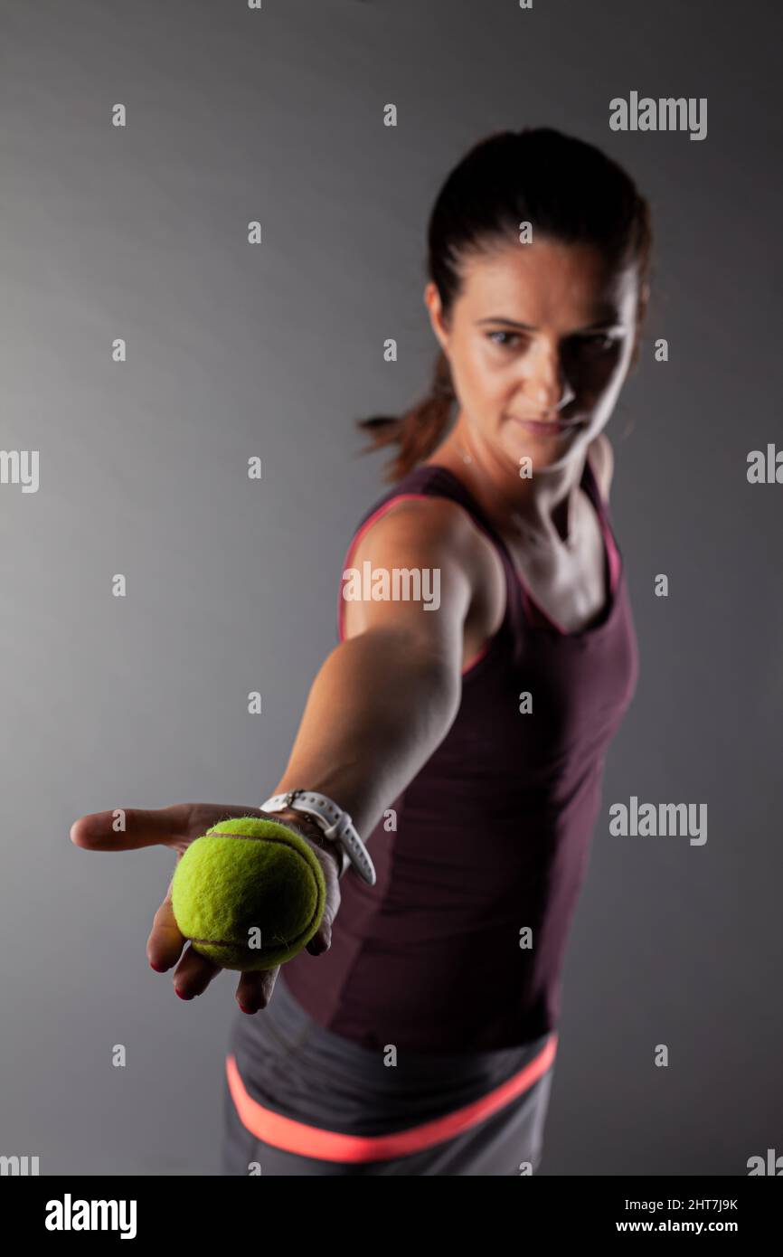 Professional female tennis player. Girl swinging racket preparing to ...