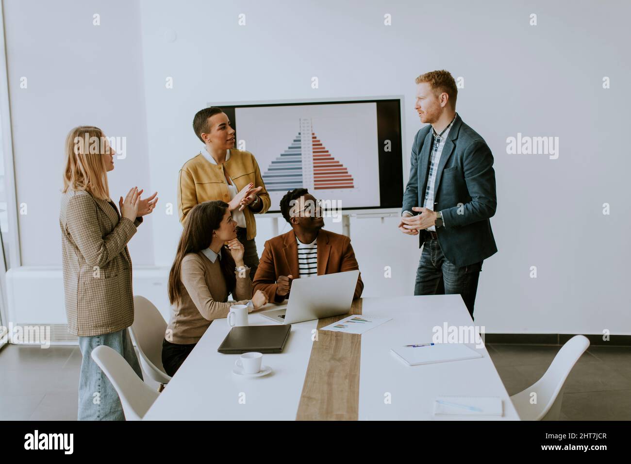 Group of young multiethnic business people working together and preparing new project on a meeting in the office Stock Photo