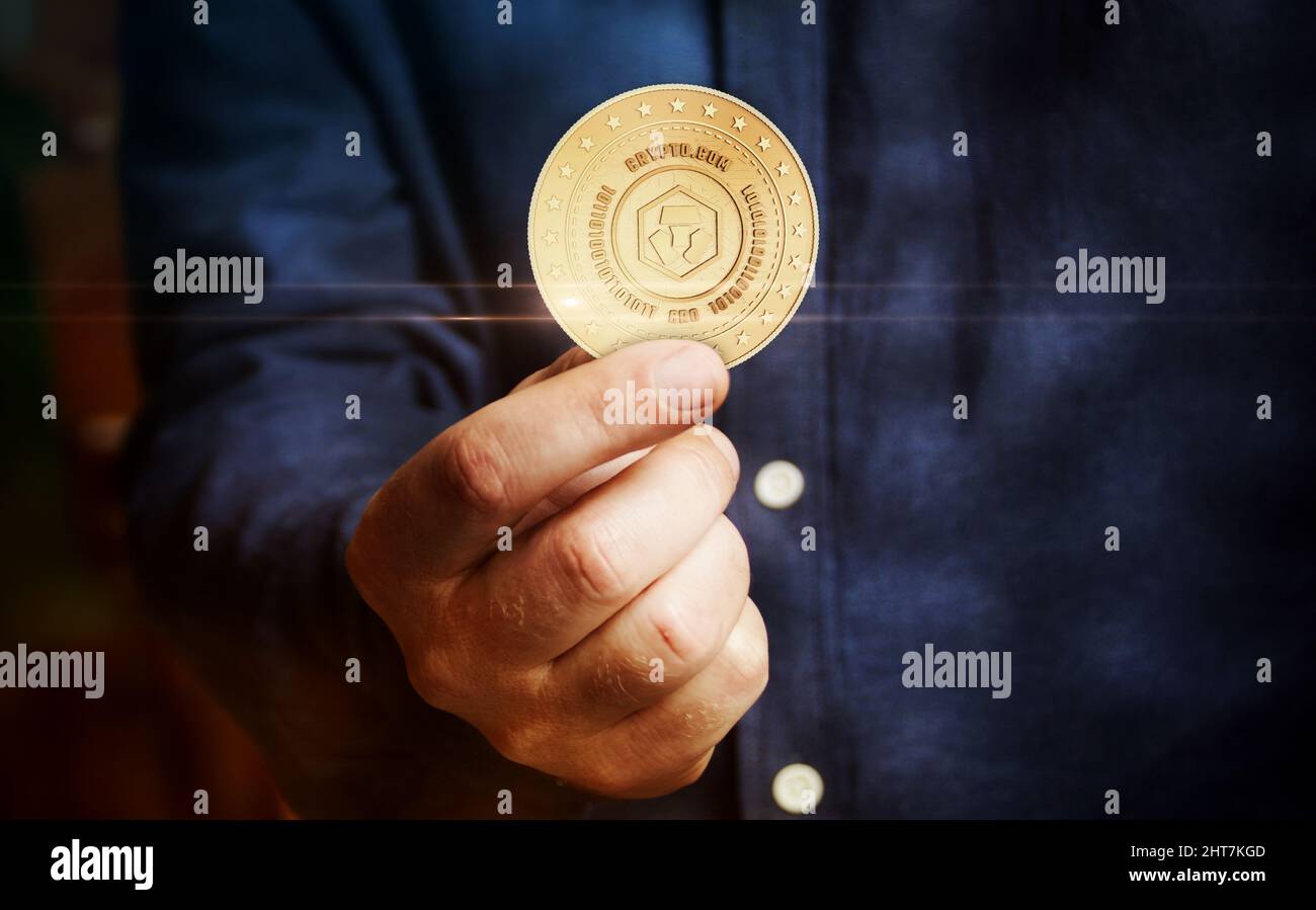 Crypto.com CRO cryptocurrency symbol golden coin in hand abstract concept  Stock Photo - Alamy