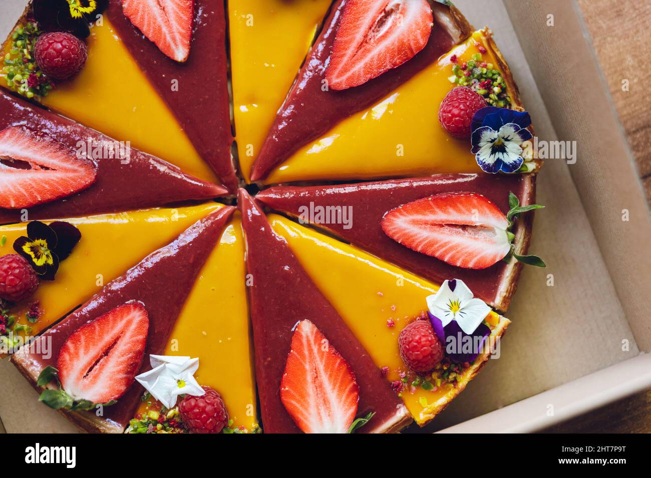 Mango and strawberry cheesecake with strawberry and raspberry on top ...