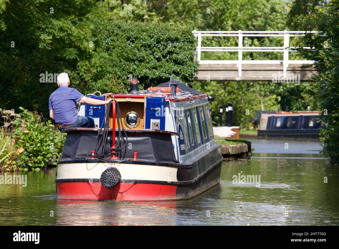 Elderly man sitting on a boat in a canal in England, UK Stock Photo - Alamy