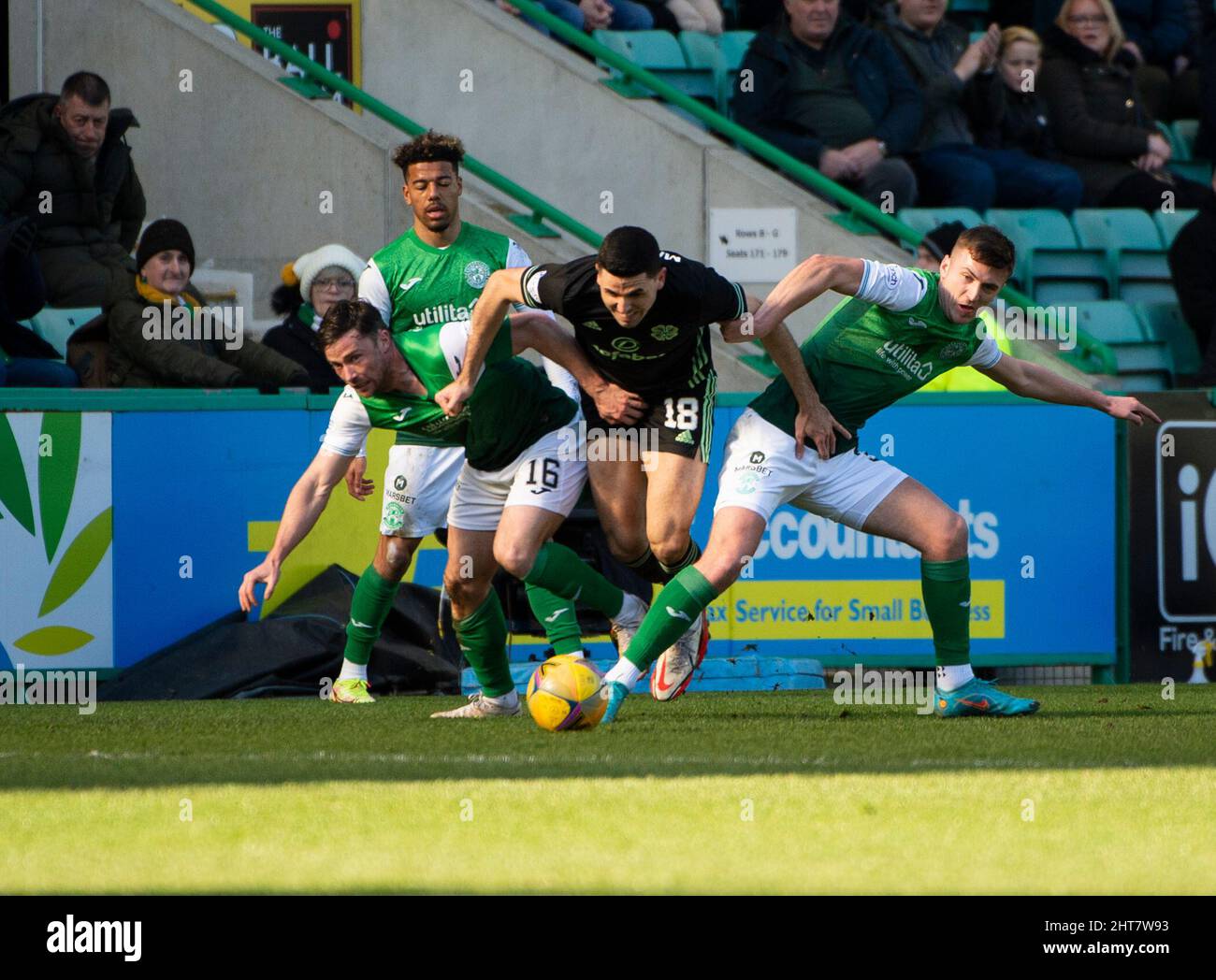 Edinburgh, UK. 27th Feb, 2022. EASTER ROAD STADIUM, EDINBURGH, SCOTLAND - FEBRUARY 27: Celtic's Australian midfielder, Tomas Rogić, bursts between Hibs' midfielders, Lewis Stevenson and Josh Campbell, during the Cinch Scottish Premiership match between Hibernian FC and Celtic FC at on February 27, 2022 in Edinburgh, United Kingdom. ( Credit: Ian Jacobs/Alamy Live News Stock Photo