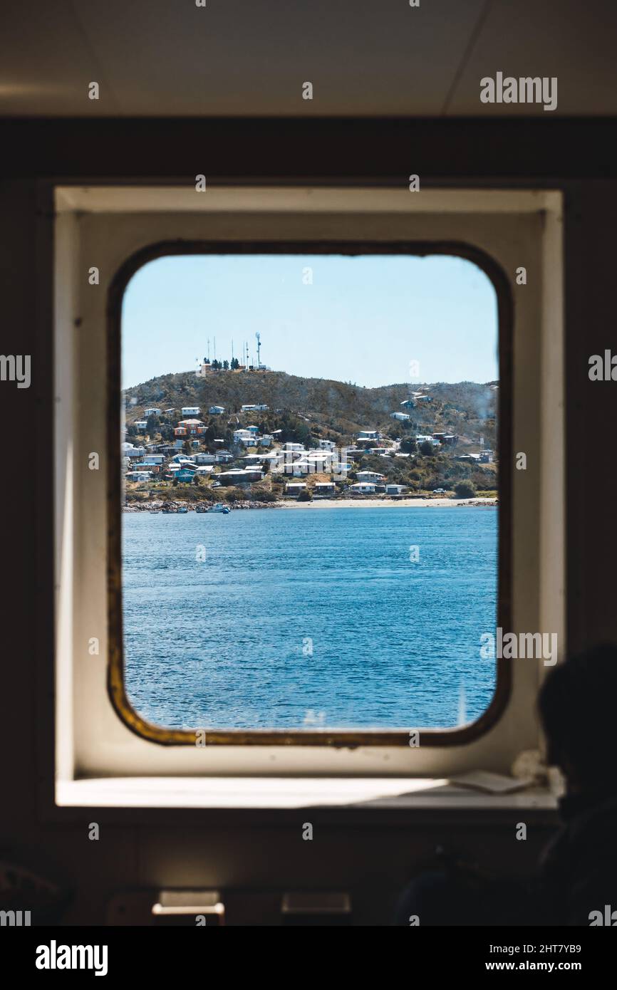Small town on an island seen from the inside of a ship. Aysén, Chile Stock Photo