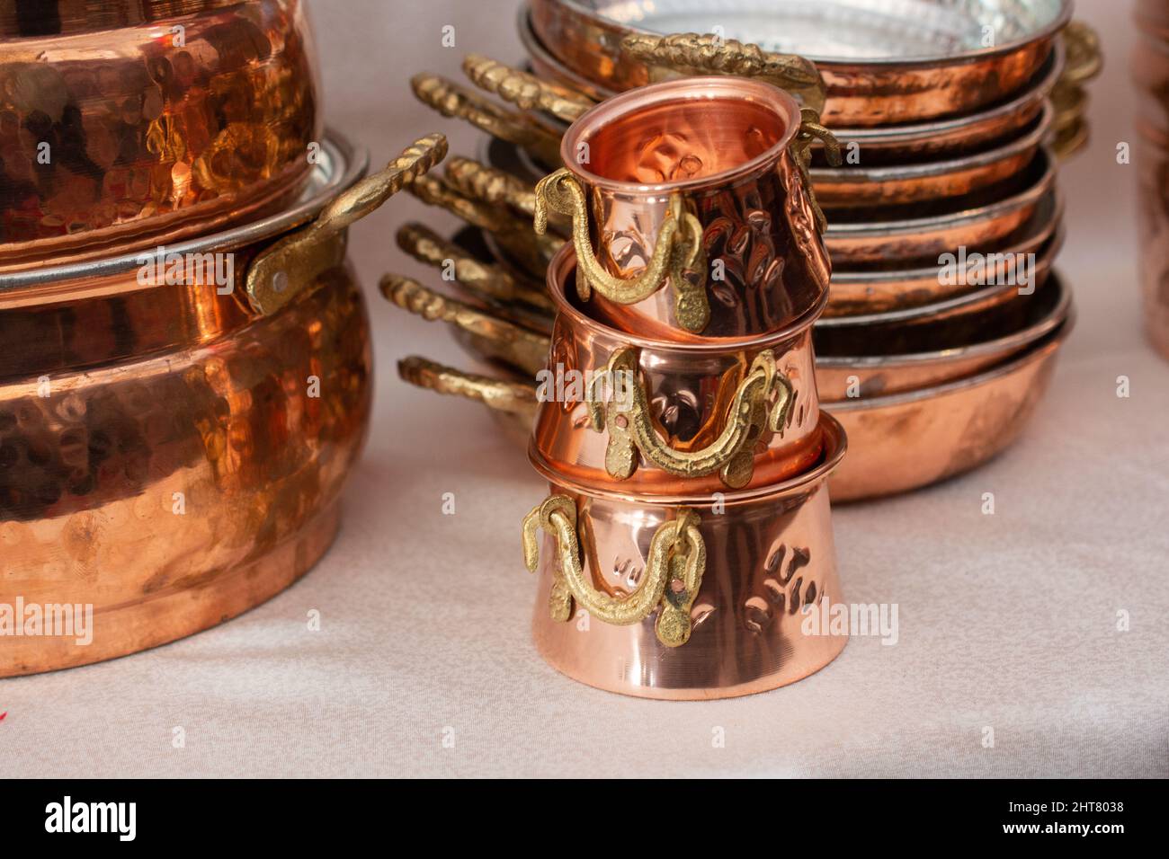 A closeup of a stack copper kitchenware placed one over another Stock Photo