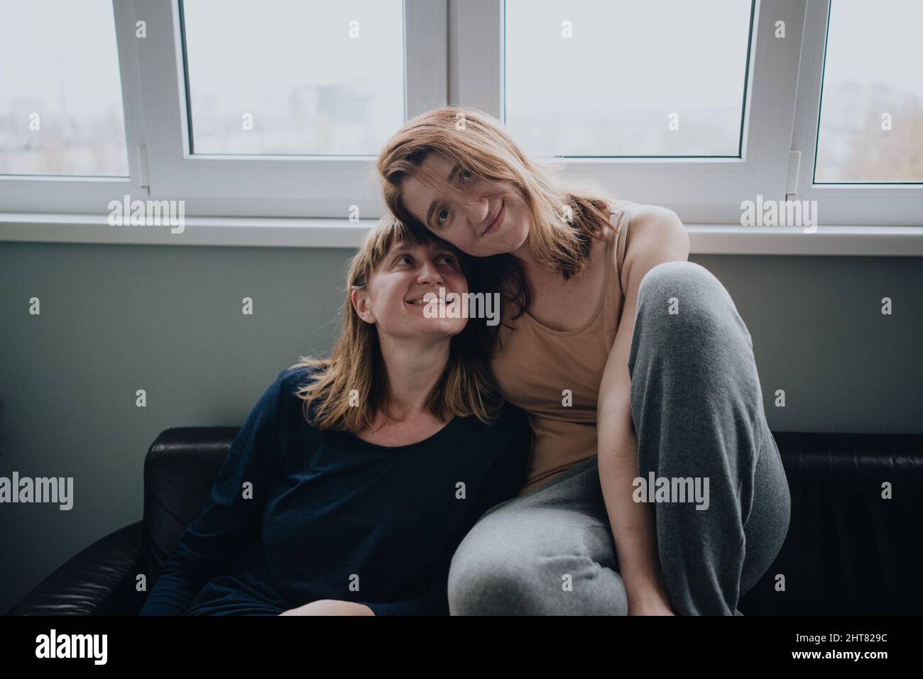 Two sisters in their home smile Stock Photo