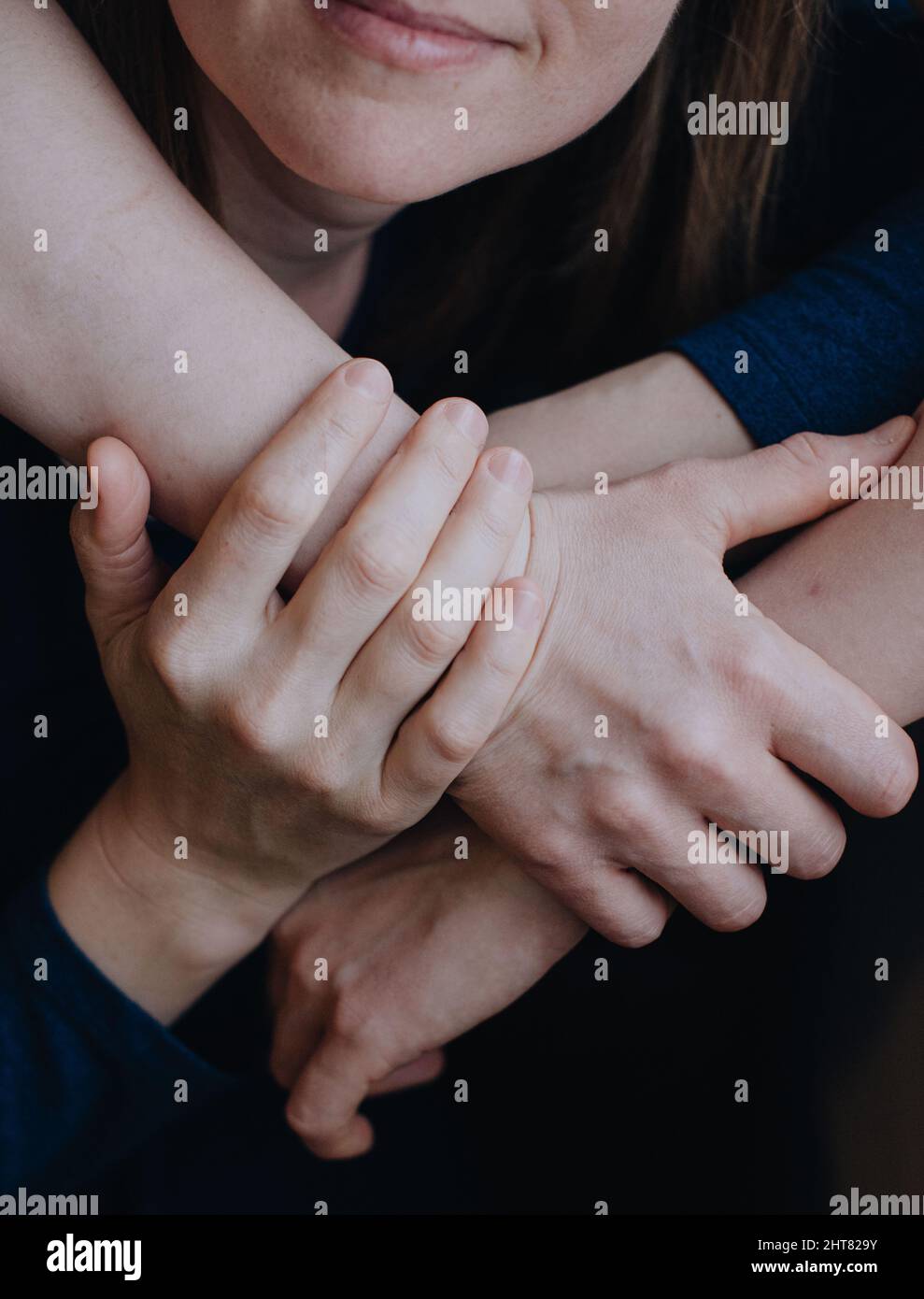 hugging hands of two woman Stock Photo
