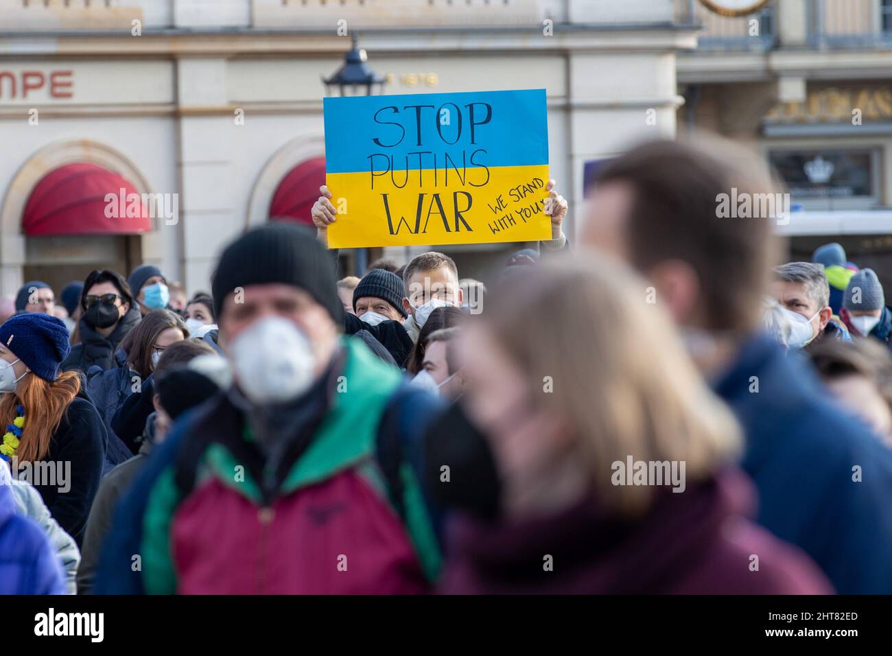 Dresden, Germany. 27th Feb, 2022. A man holds a placard reading 'Stop Putin's War' at a demonstration on Neumarkt square against the Russian attack on Ukraine. According to police, more than 3,000 people came together after a call by the parties in Dresden. Credit: Daniel Schäfer/dpa-Zentralbild/dpa/Alamy Live News Stock Photo