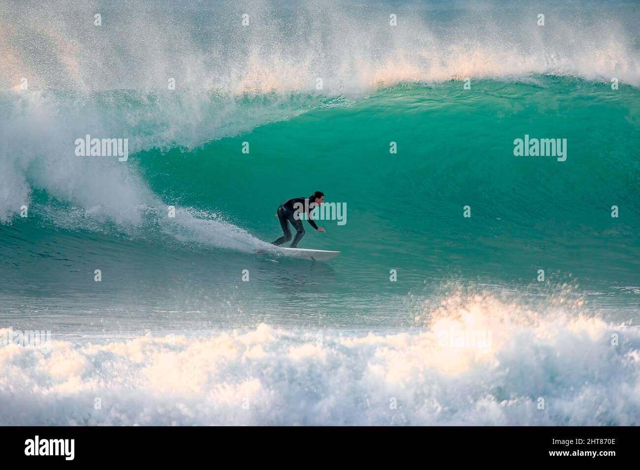 Surfer riding a big wave in Cornwall Stock Photo - Alamy