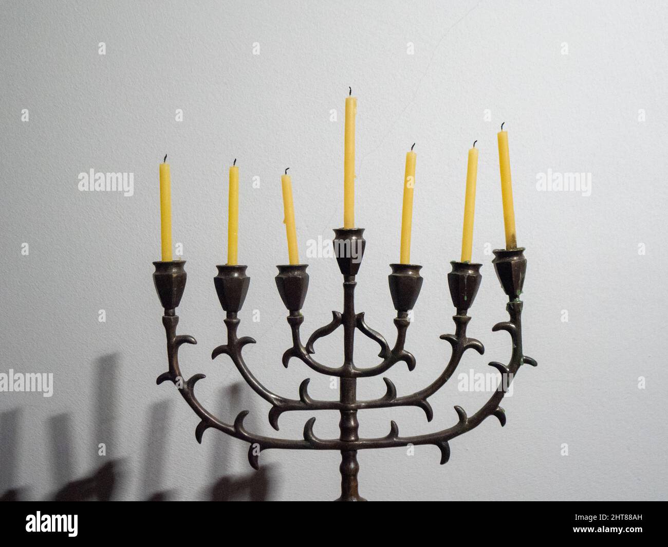 Closeup shot of a seven-branched candelabra with candles on a white background for Hanukkah Stock Photo