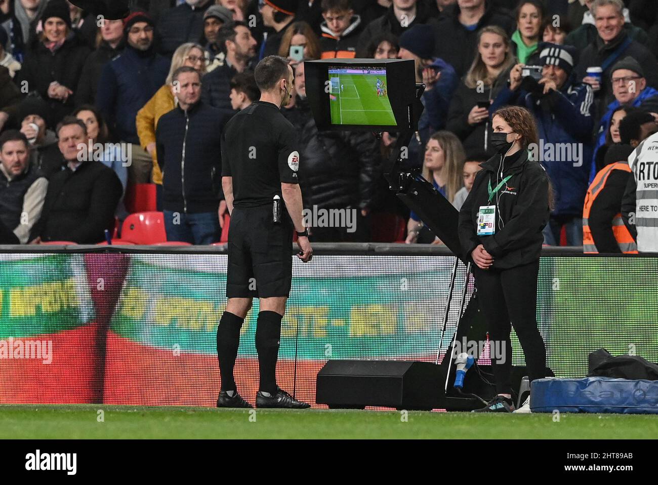 Referee Stuart Attwell checks the VAR screen before ruling Joel Matip #32 of Liverpool’s goal offside Stock Photo
