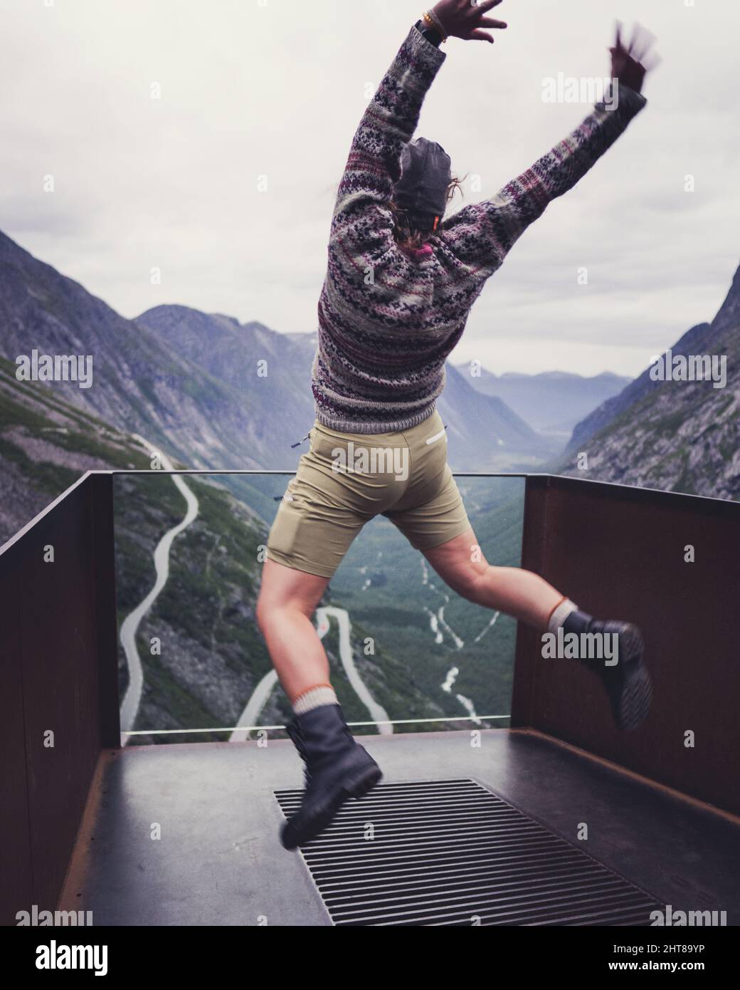 Hiker jumping on a mountain background Stock Photo - Alamy