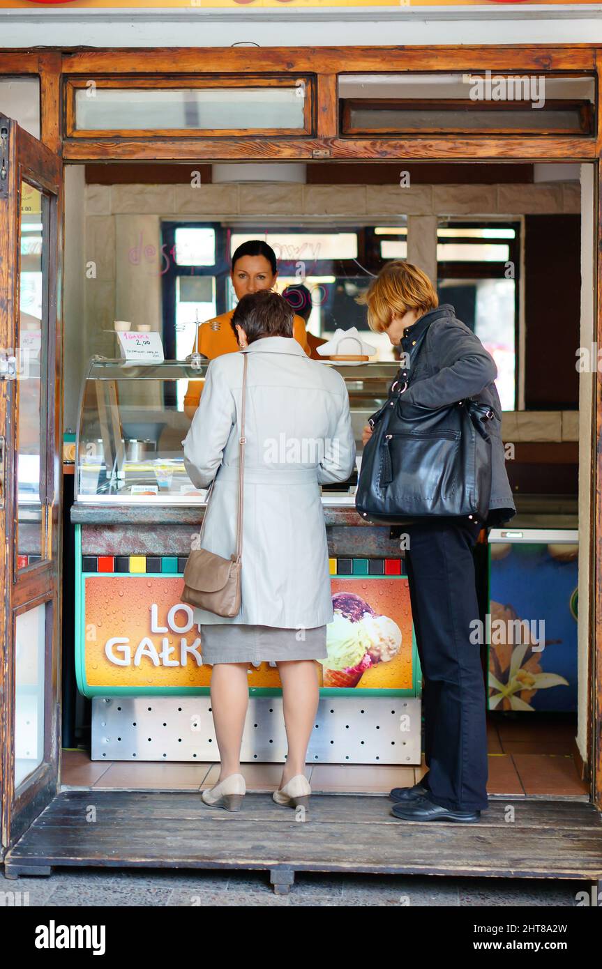 Closeup of two women buying ice cream by a stand Stock Photo Alamy