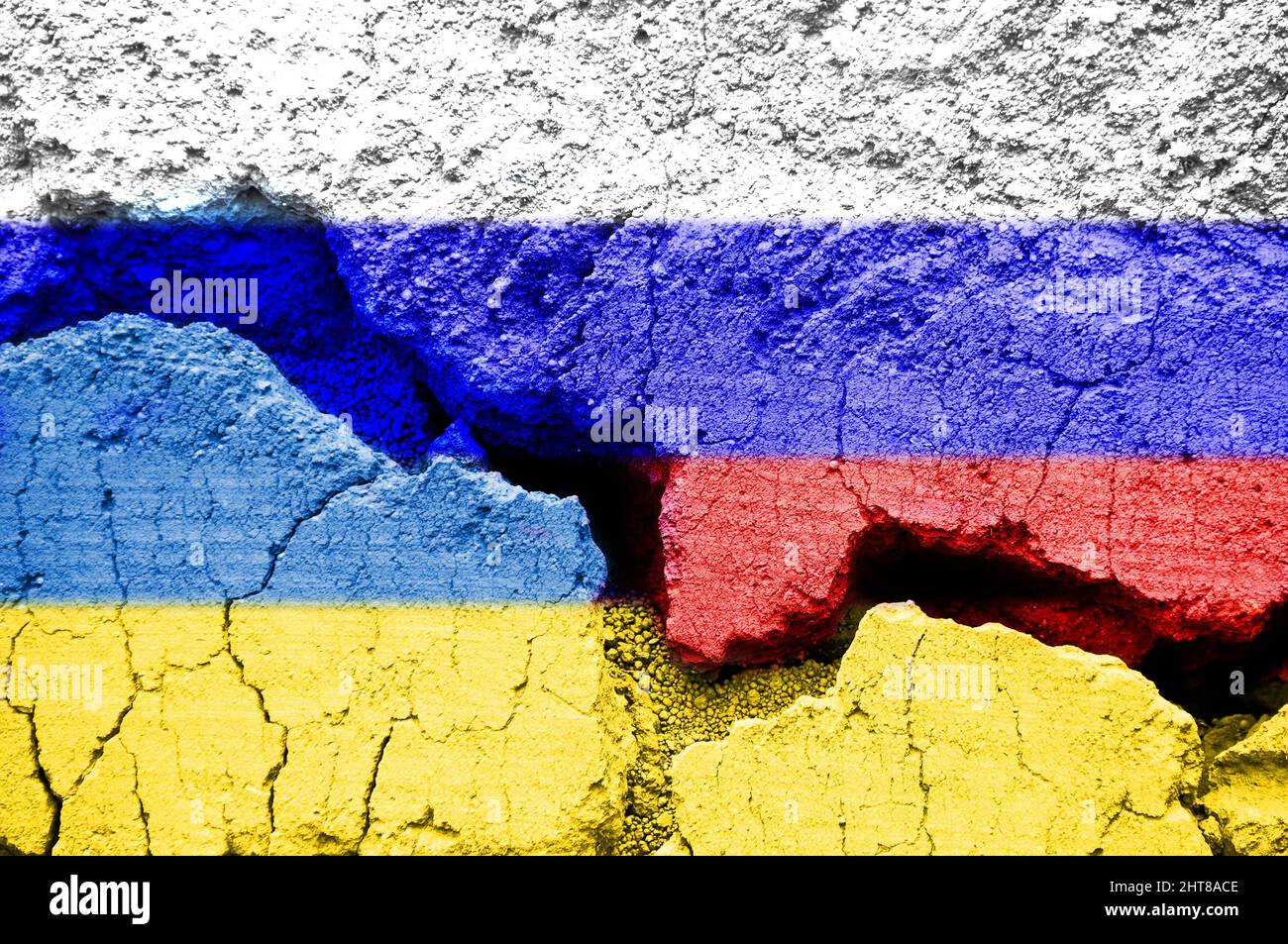 Russian and Ukrainian flag on cracked ground background. Ukraine Russia war concept Stock Photo