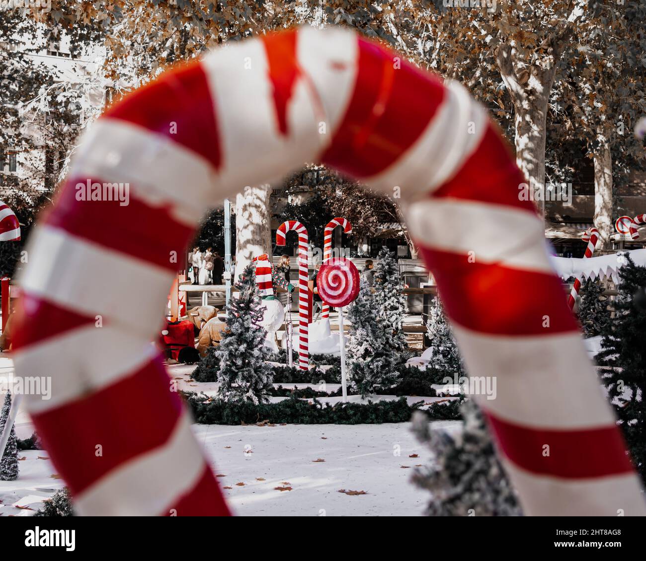 View of big decorative lollipops in a park through another red and