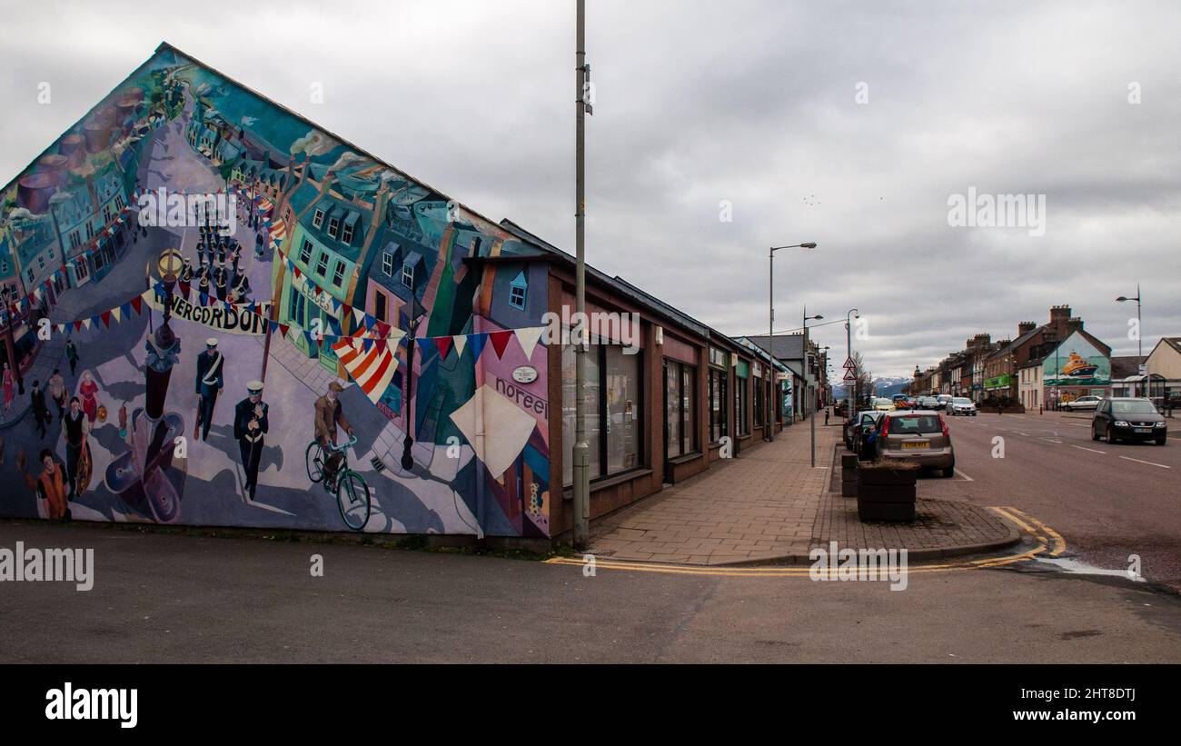 A mural painted on the side of shops celebrates the town's history on Invergordon High Street in Scotland. Stock Photo