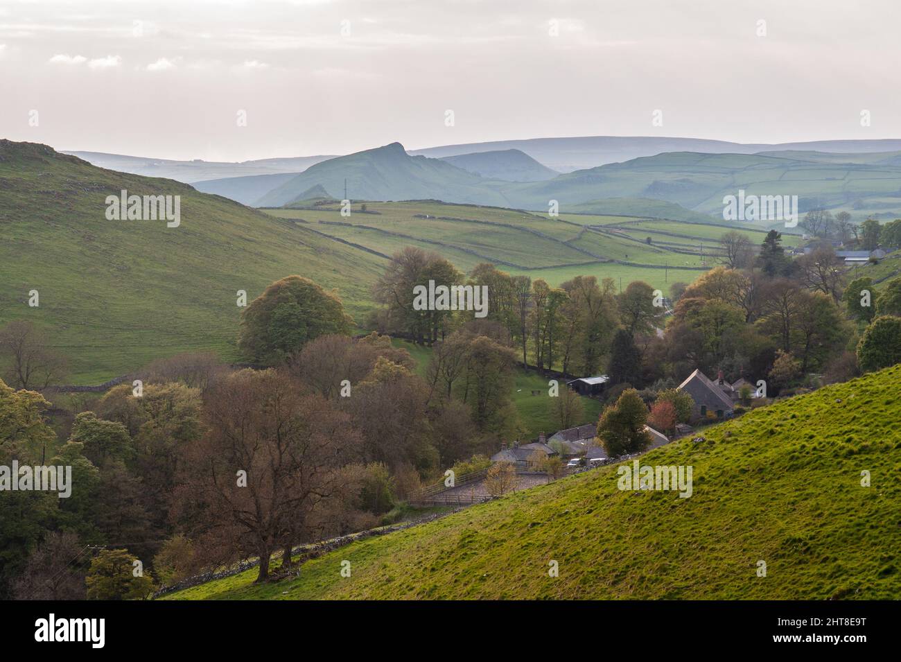 Earl Sterndale village is nestled in a valley under the hills of England's Peak District, including the distinctive Chrome Hill and Parkhouse Hill. Stock Photo