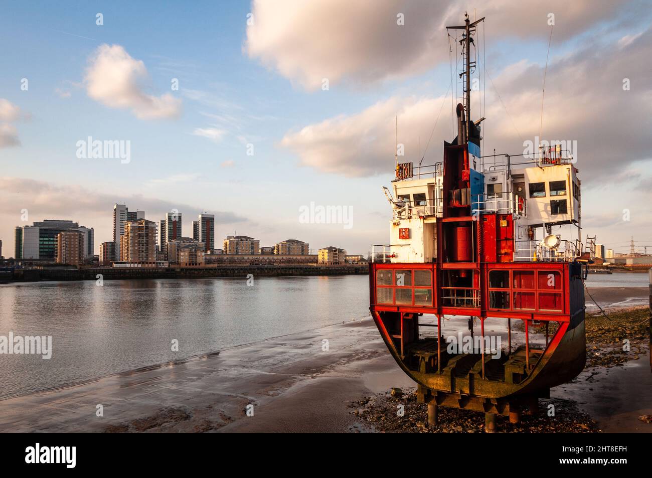 London, England, UK - March 22, 2009: A segment of a small cargo ship rests on the side of the River Thames at North Greenwich, an art installation by Stock Photo