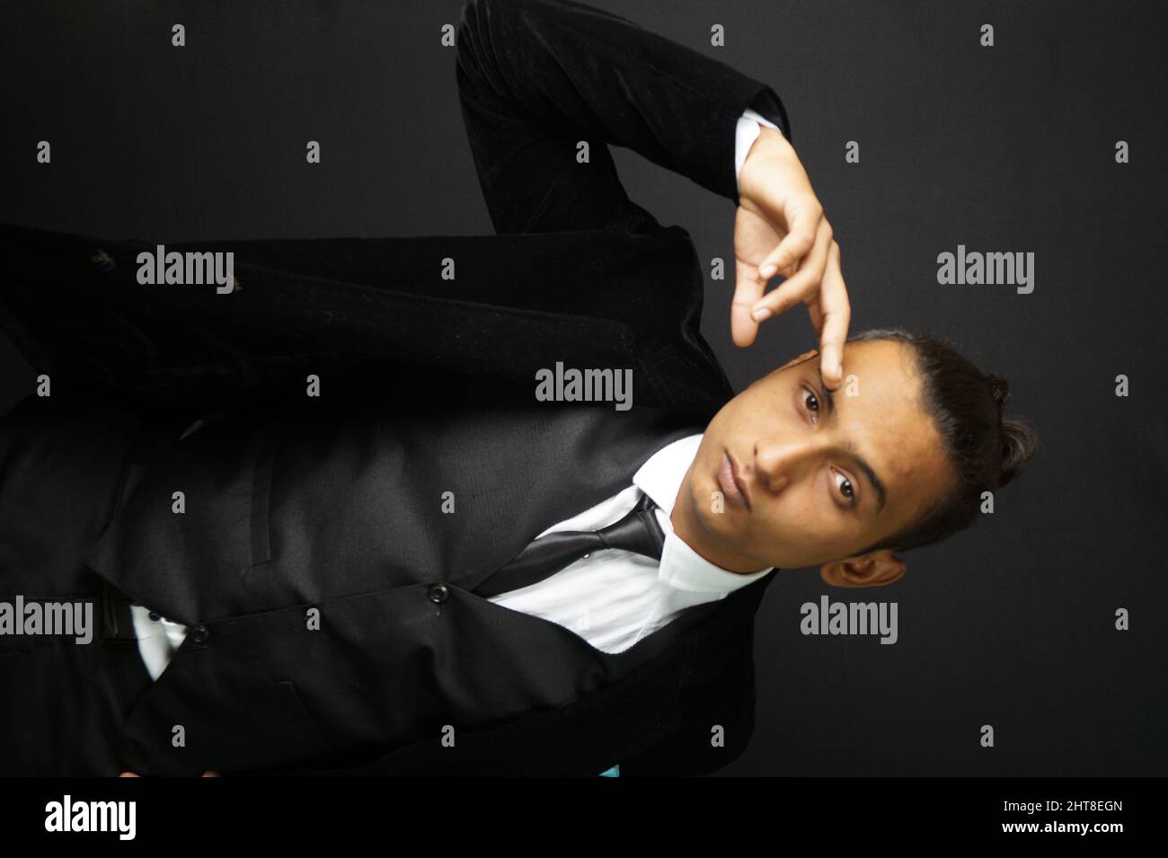 Closeup of a man posing for a photo in a studio Stock Photo Alamy
