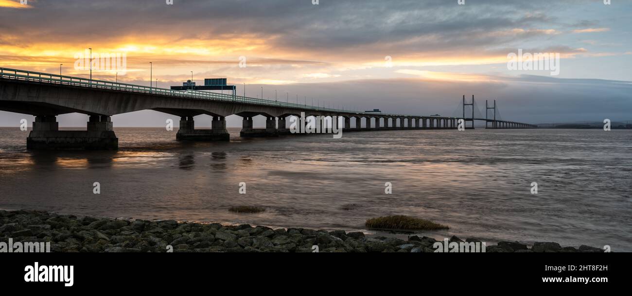 Sunset lights up the sky over the Second Severn Crossing bridge on the Bristol Channel. Stock Photo