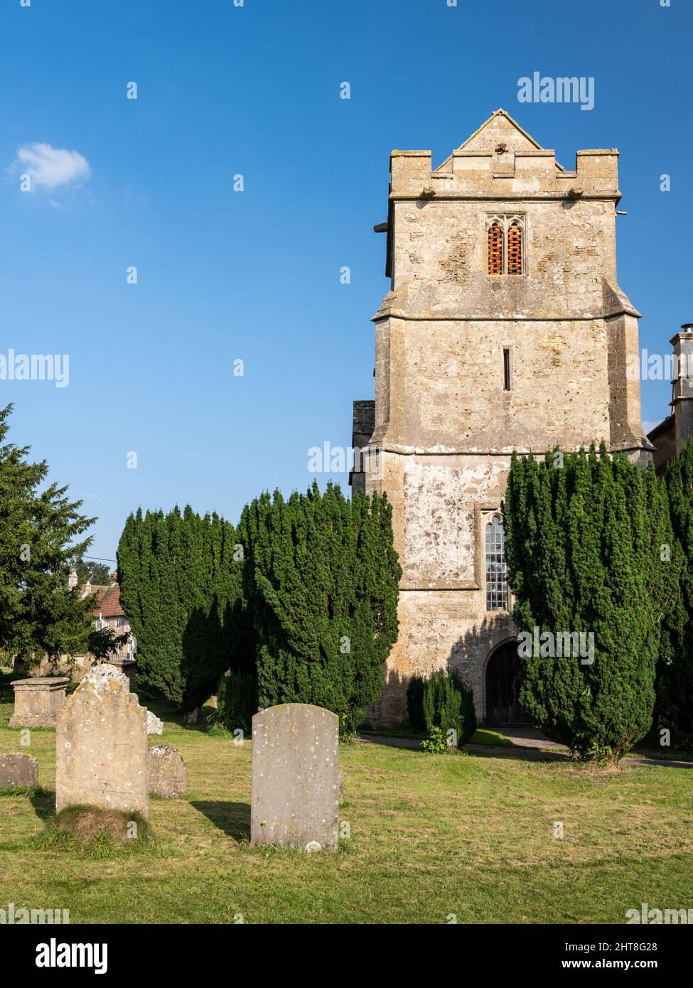 Sun shines on the traditional parish church of St Michael and All Angels in Atworth, Wiltshire. Stock Photo