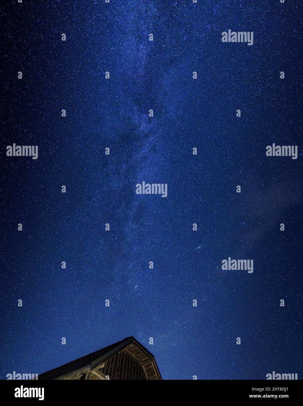 Vertical shot of the beautiful Milky Way in the night sky full of stars ...