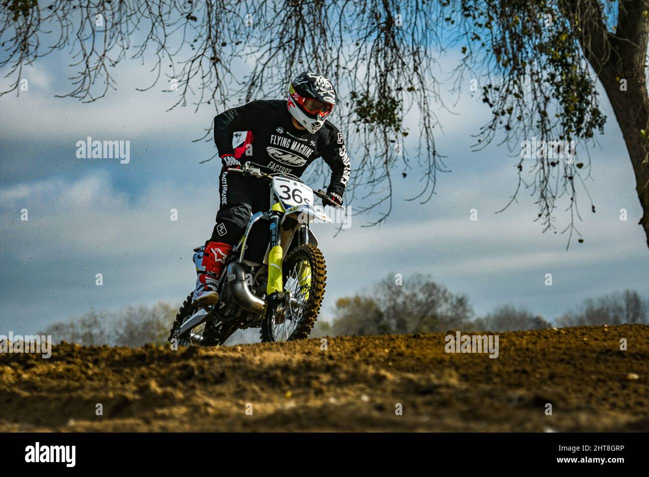 Professional rider with a helmet in a motocross race on a sand track in ...