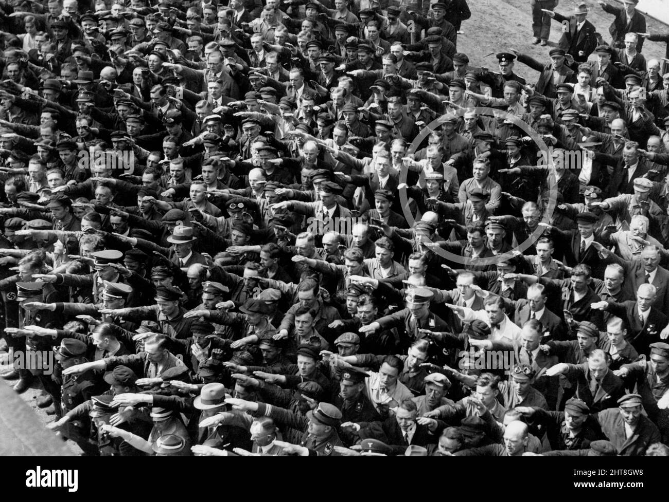 Picture of people giving a Nazi salute, with an unidentified person (possibly August Landmesser or Gustav Wegert) refusing to do so - 1936 Stock Photo
