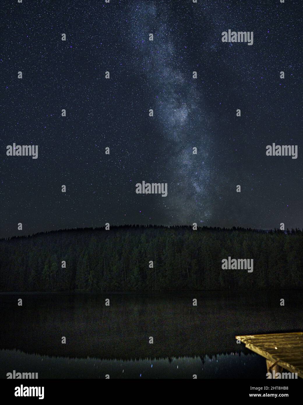 Vertical shot of the beautiful Milky Way in the night sky full of stars ...