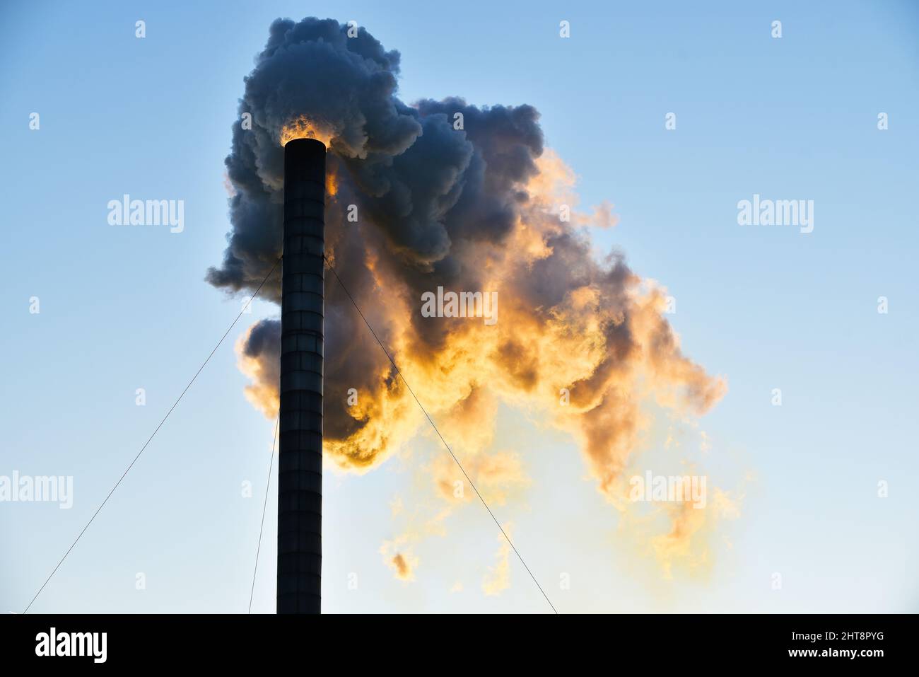 Industrial chimney pipe emits toxic polluting smoke Stock Photo