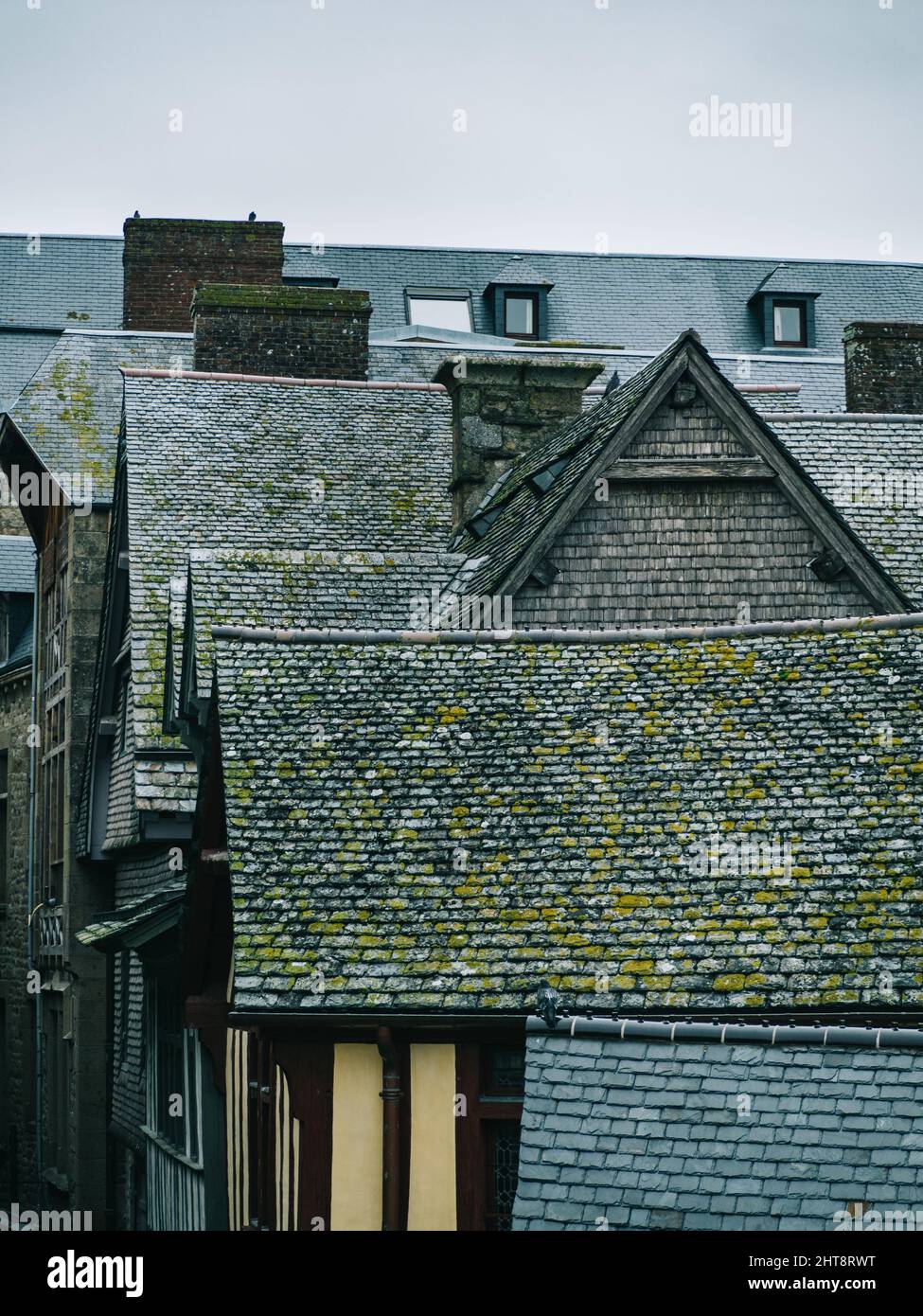 Vertical shot of a line of houses with medieval rooftops Stock Photo