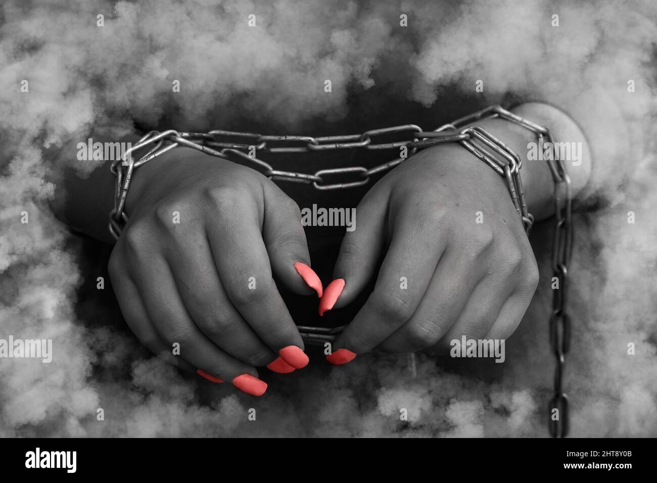 Woman's hands tied with a chain - discolored conceptual photo Stock Photo