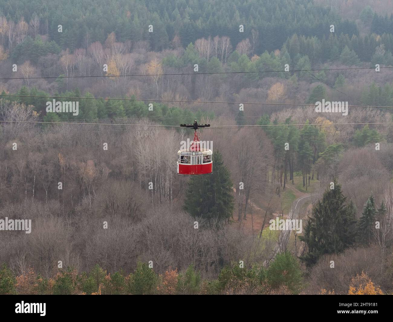 Cable Car Rides Scotland A red retro style cable car rides over huge park area. Resort ...