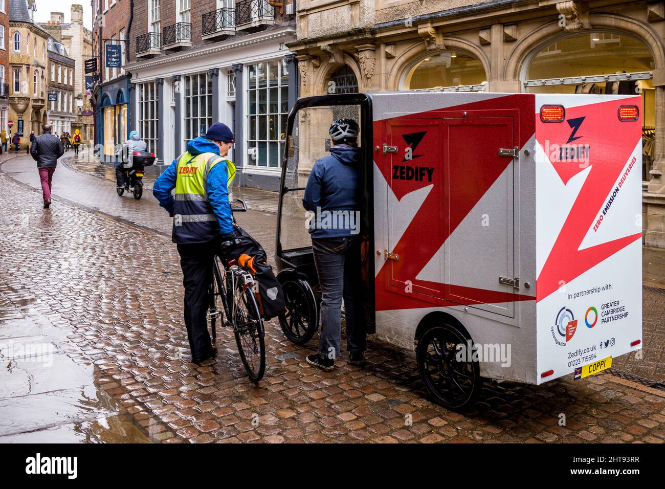 A large electric cargo delivery bike from the Zedify local logistics company parked on Trinity St Central Cambridge. Eco Delivery Solutions. Stock Photo