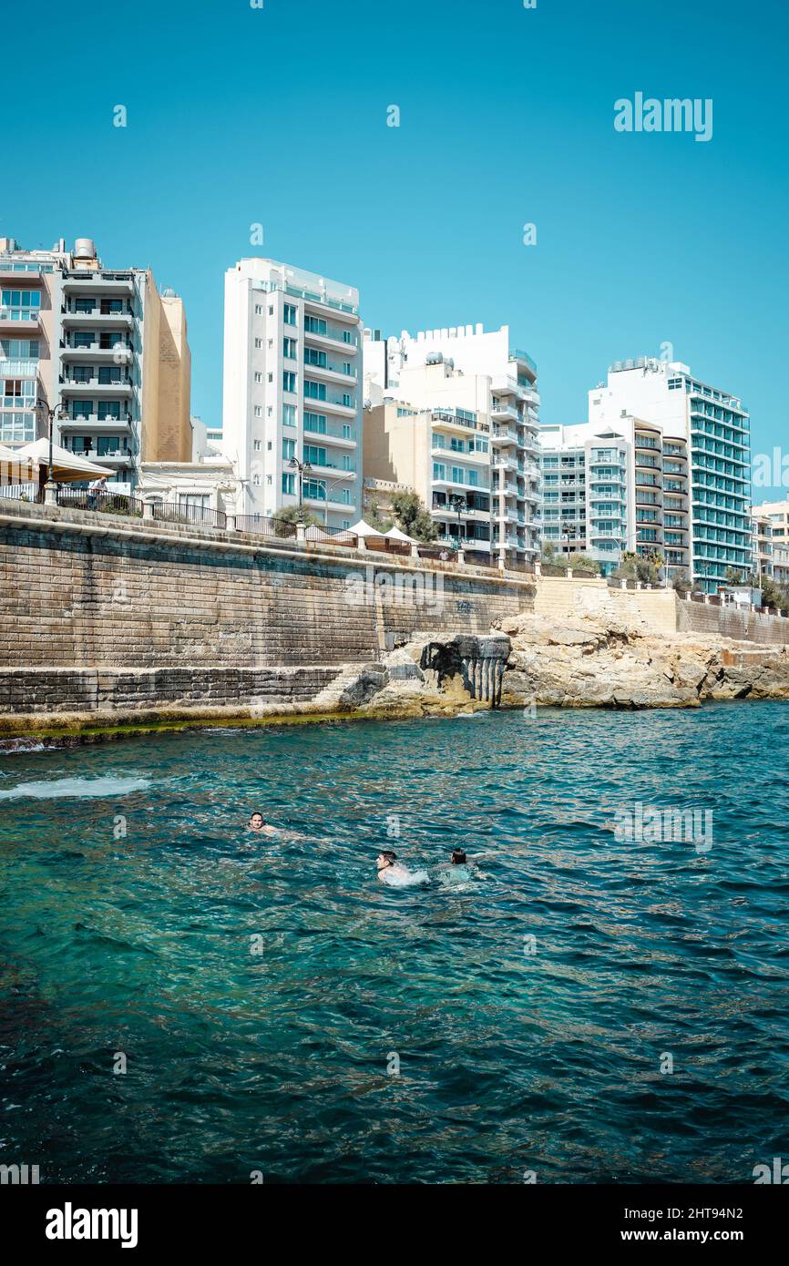 Vertical shot of modern buildings near the water on a sunny day Stock ...