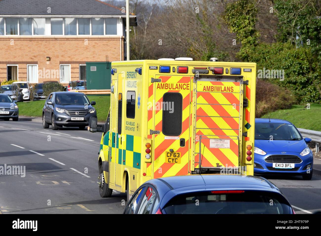 Pontypridd, Wales - February 2022: Amebulance driving in traffic without blue lights flashing Stock Photo