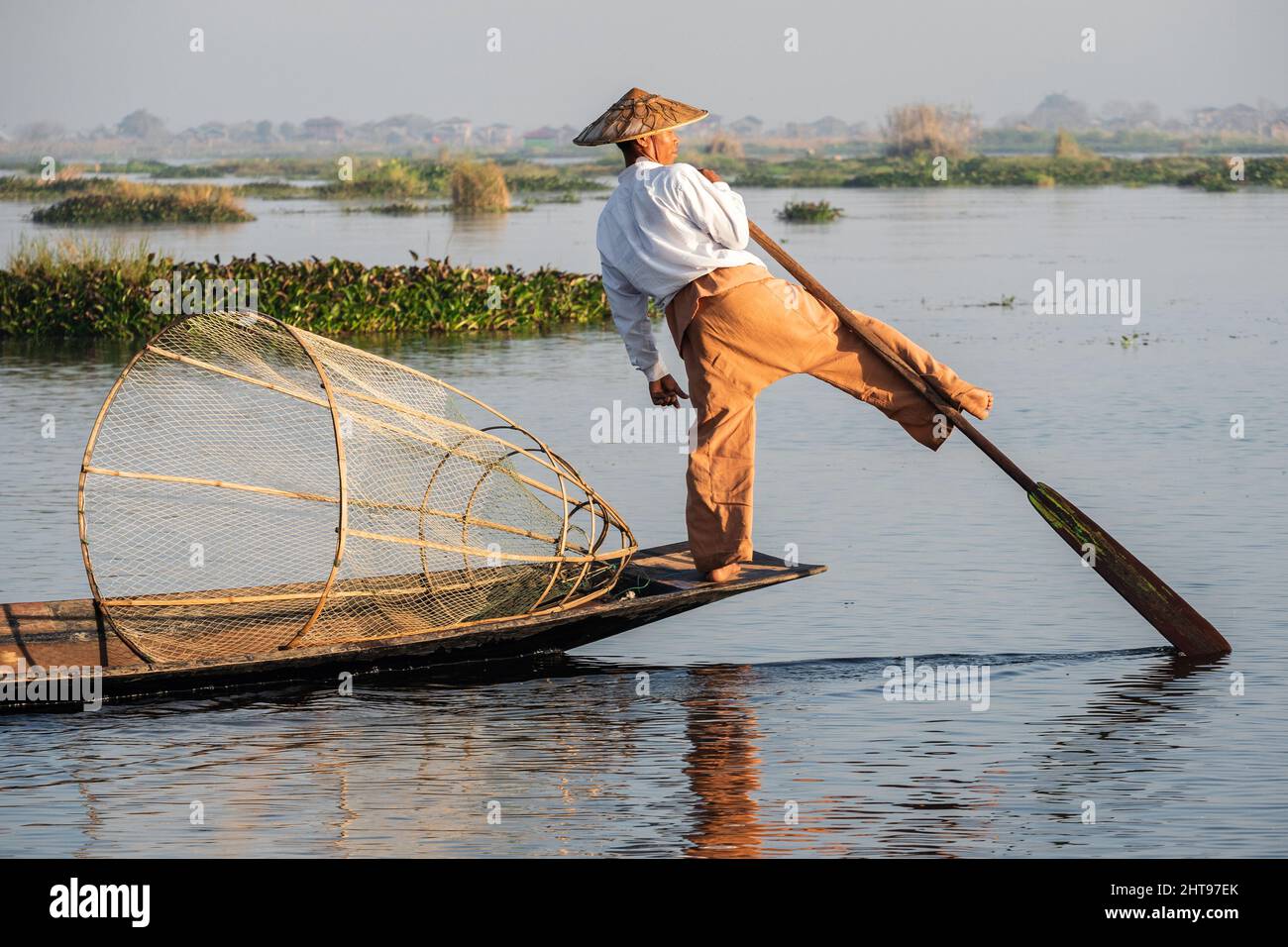 Intha fisherman leg rowing in traditional style on Inle Lake, Shan State, Myanmar (Burma). Stock Photo