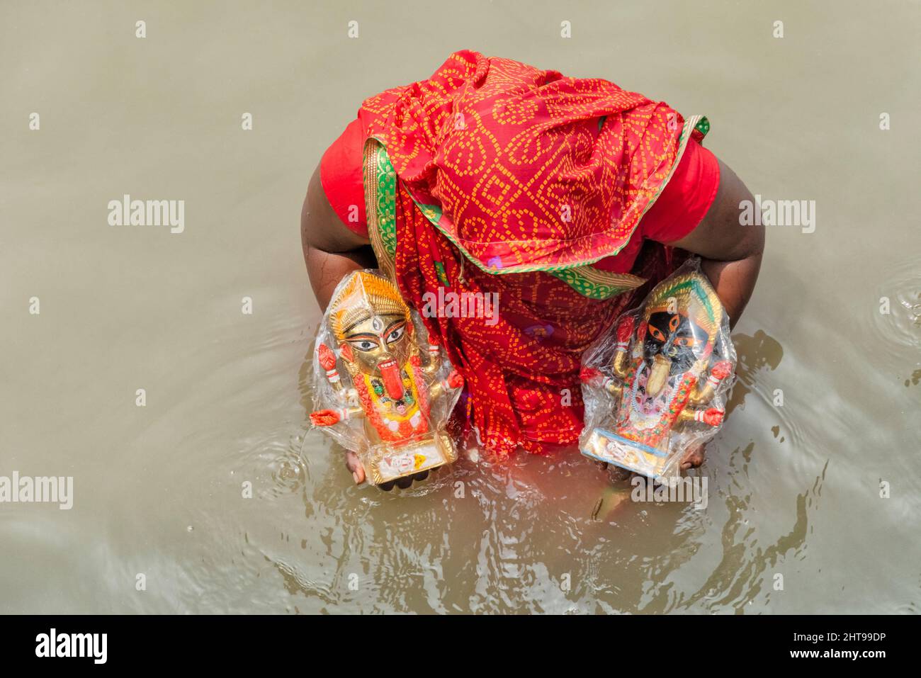 Woman taking a holy dip in Ganges River, Kolkata, West Bengal, India Stock Photo