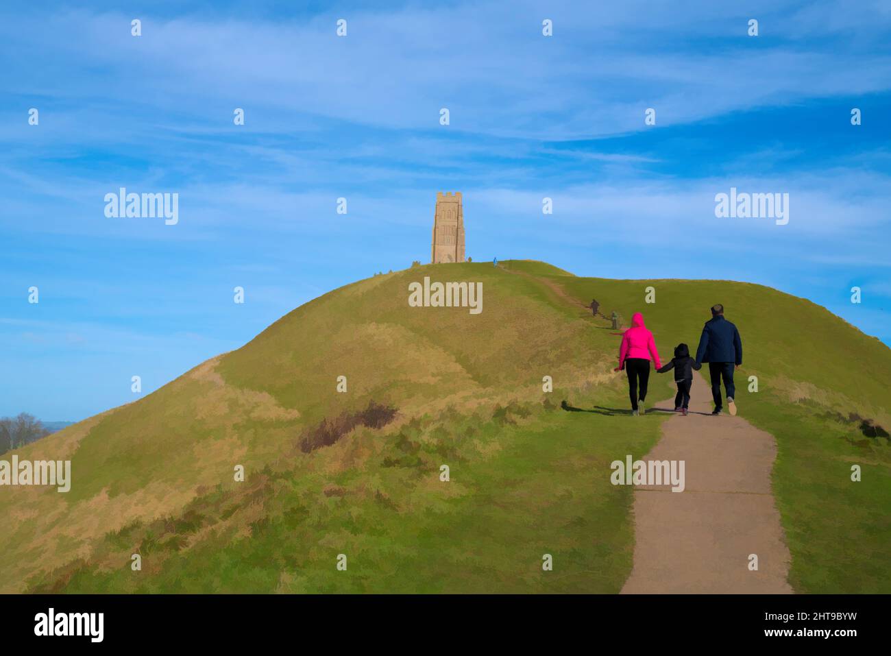 Glastonbury Tor Hill Somerset with family walking up hill England UK Stock Photo