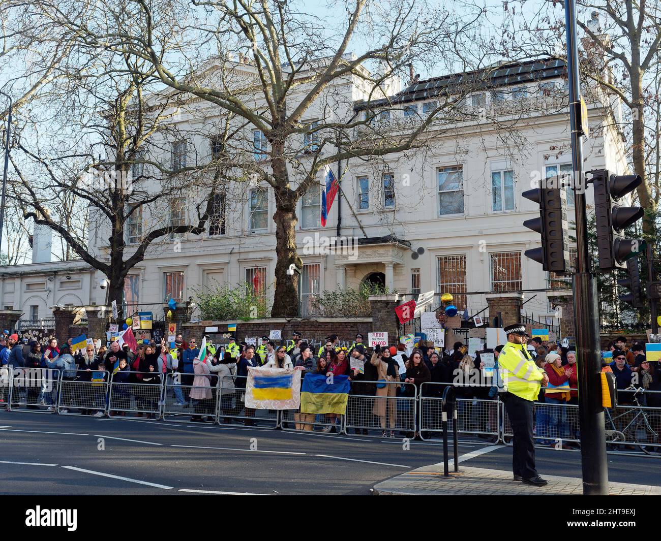 Protesters gathered in front of the Russian Embassy in London waving flags, banners and placards to protest at the Russian invasion of Ukraine Stock Photo